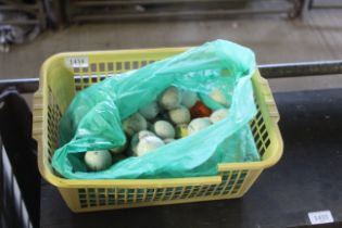 A plastic crate containing various used golf balls