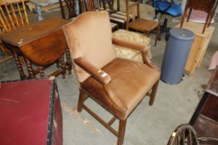 A wooden framed and upholstered elbow chair