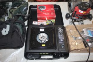 A camping stove in fitted plastic case together wi