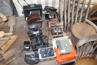 An Olympus Trip 35 camera and various other camera