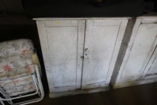 A Victorian white painted cupboard with four inter