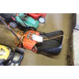 A Black & Decker GD300 electric scarifier with instruction guide