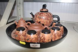 An Oriental lacquered tea set on tray and two terracotta tea pots character marks to base