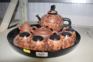 An Oriental lacquered tea set on tray and two terracotta tea pots character marks to base