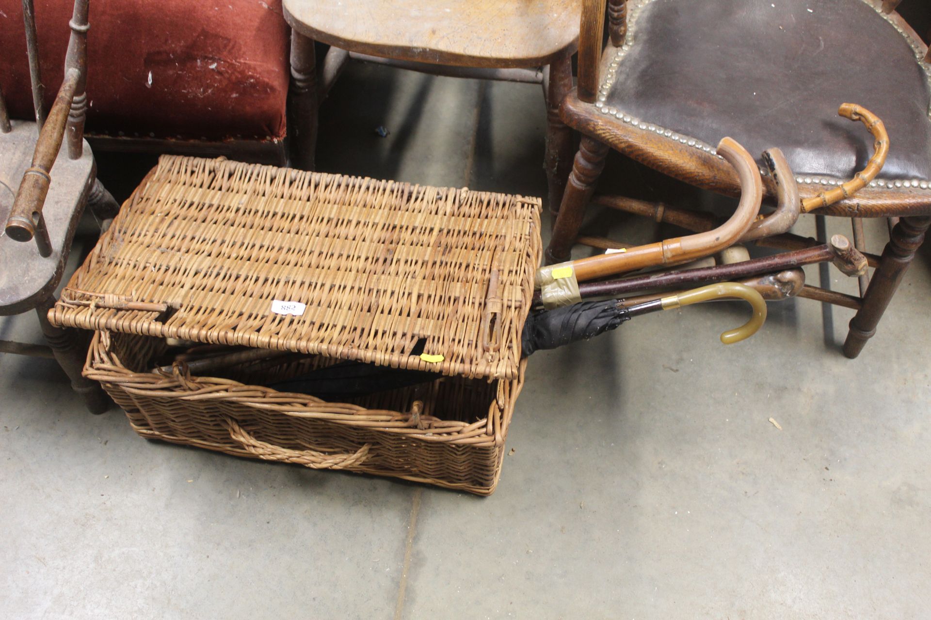 A wicker basket with contents of walking sticks an
