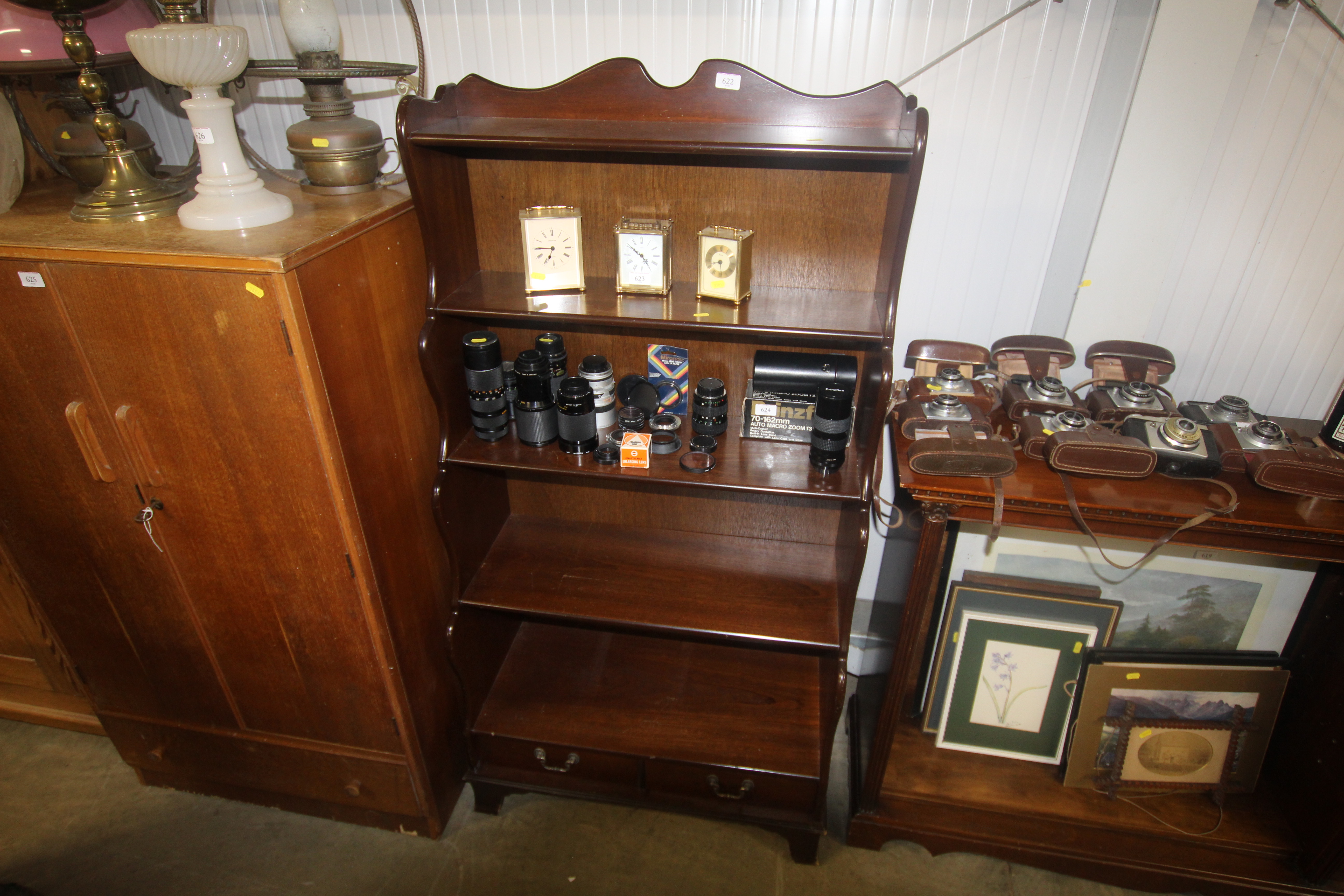 A reproduction mahogany waterfall bookcase fitted