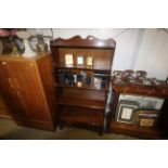 A reproduction mahogany waterfall bookcase fitted