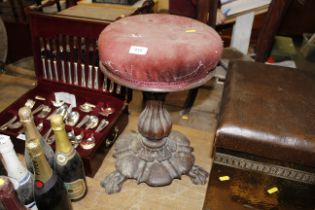 A Victorian mahogany piano stool raised on cabriole supports