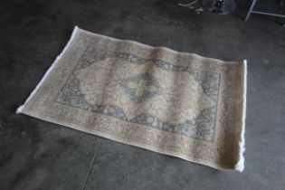 An approx. 5'7" x 3'4" patterned rug