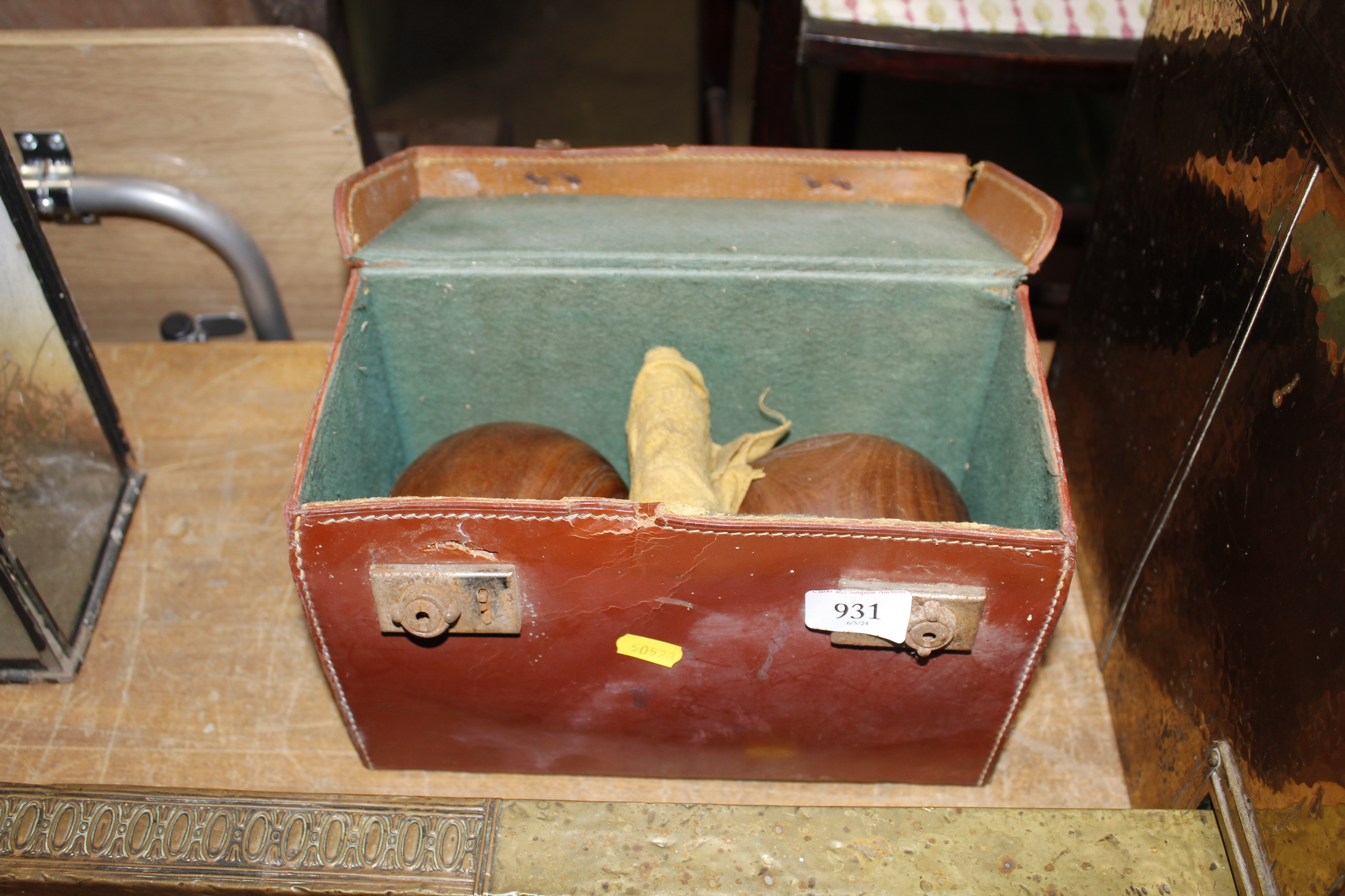 A leather case containing two bowling woods