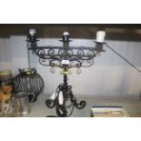 A wrought iron three branch table lamp