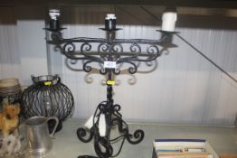 A wrought iron three branch table lamp