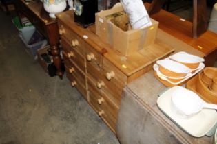 A pine chest fitted with an arrangement of ten dra