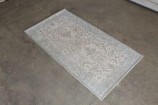 An approx. 4'10" x 2'8" modern rug