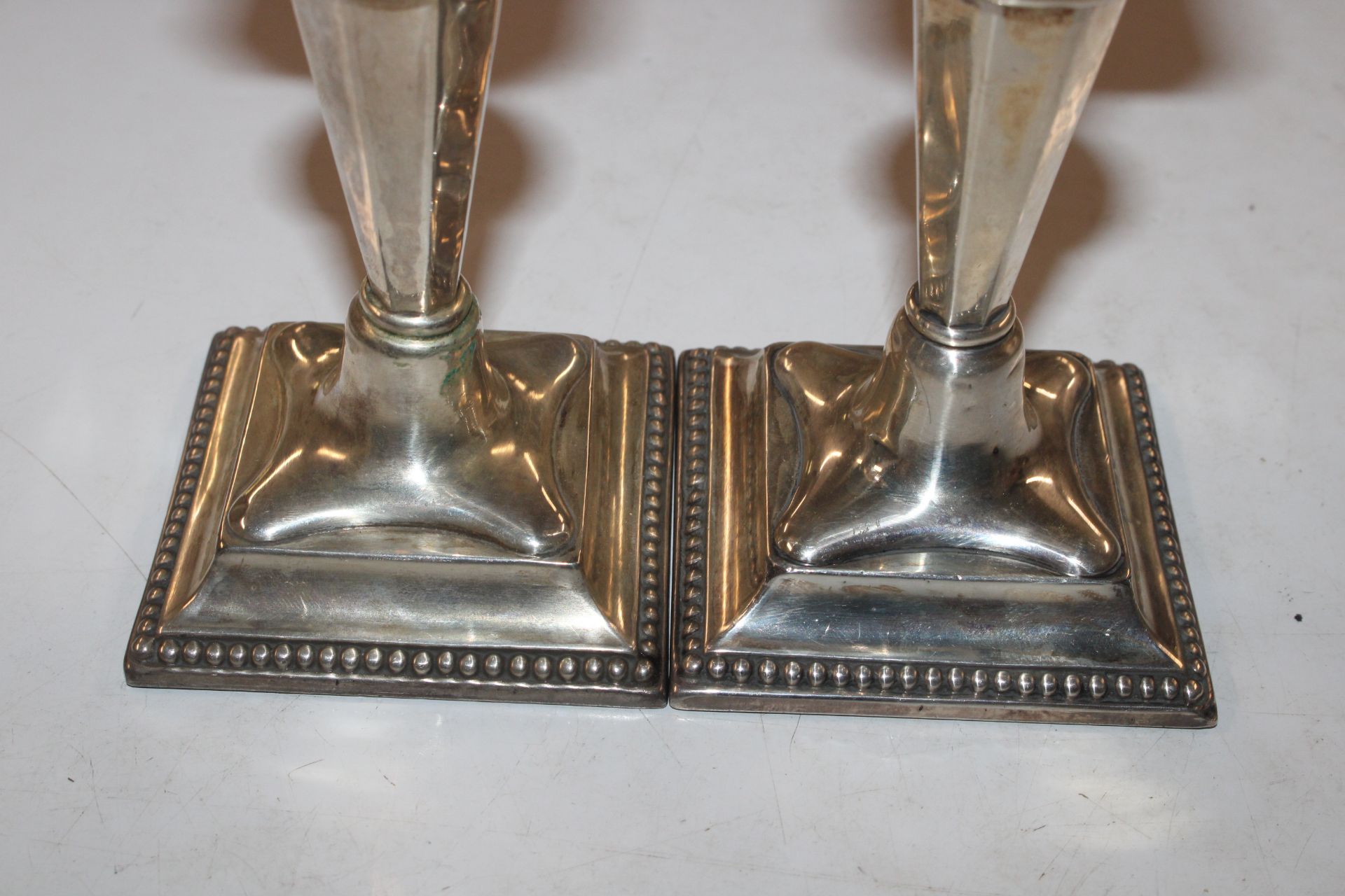 A pair of silver candlesticks with weighted bases - Image 2 of 7