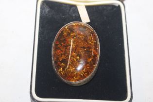 A large Sterling silver and amber brooch, approx.