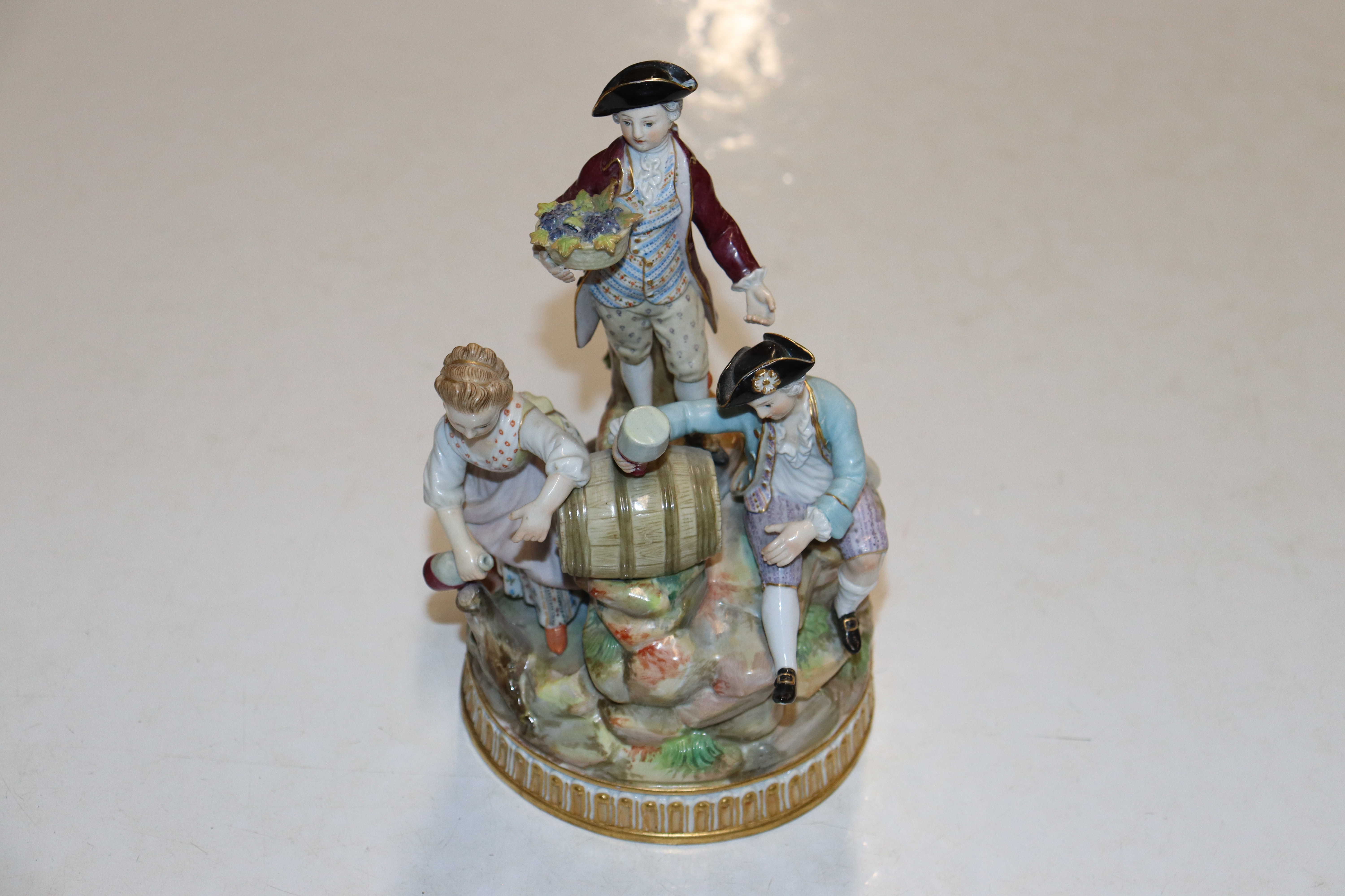 A Continental porcelain figure group having cross