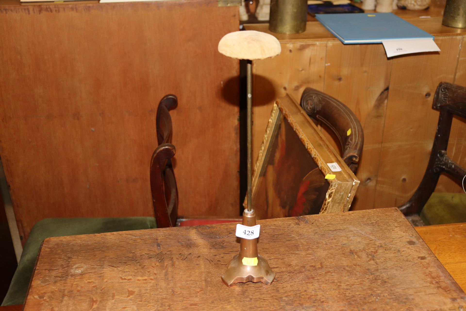 A wig stand numbered to base