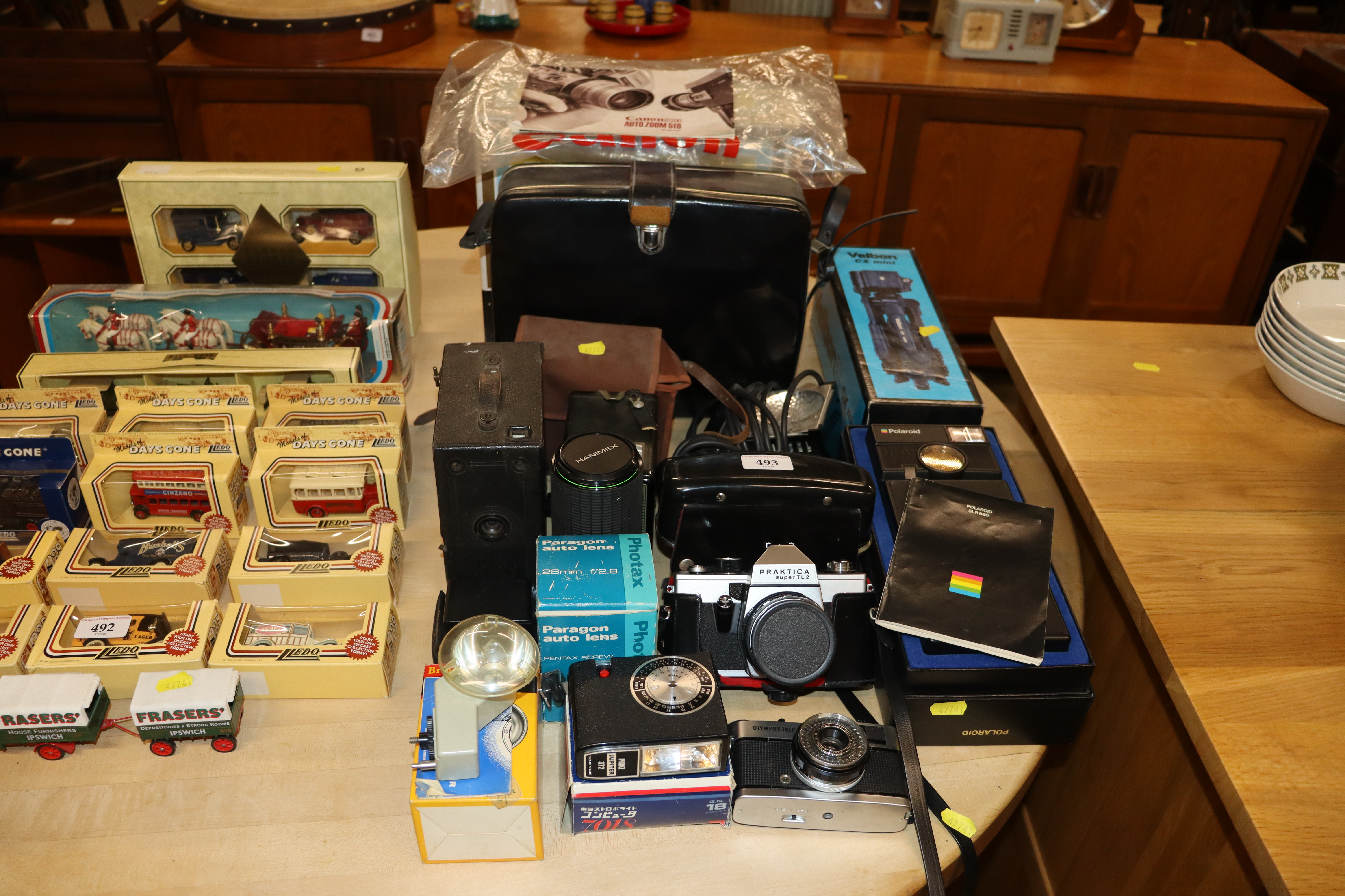 A quantity of various cameras and lenses to includ