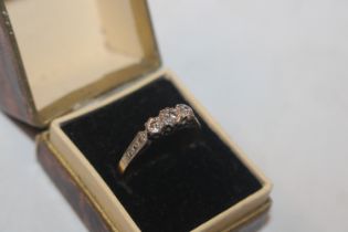 An 18ct gold and platinum three stone diamond ring