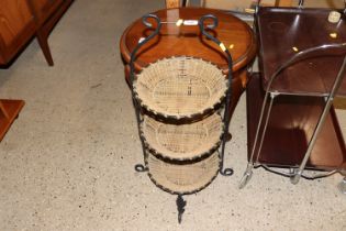 A metal and wicker three tier stand
