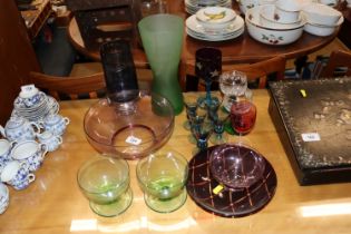 A collection of various coloured glassware