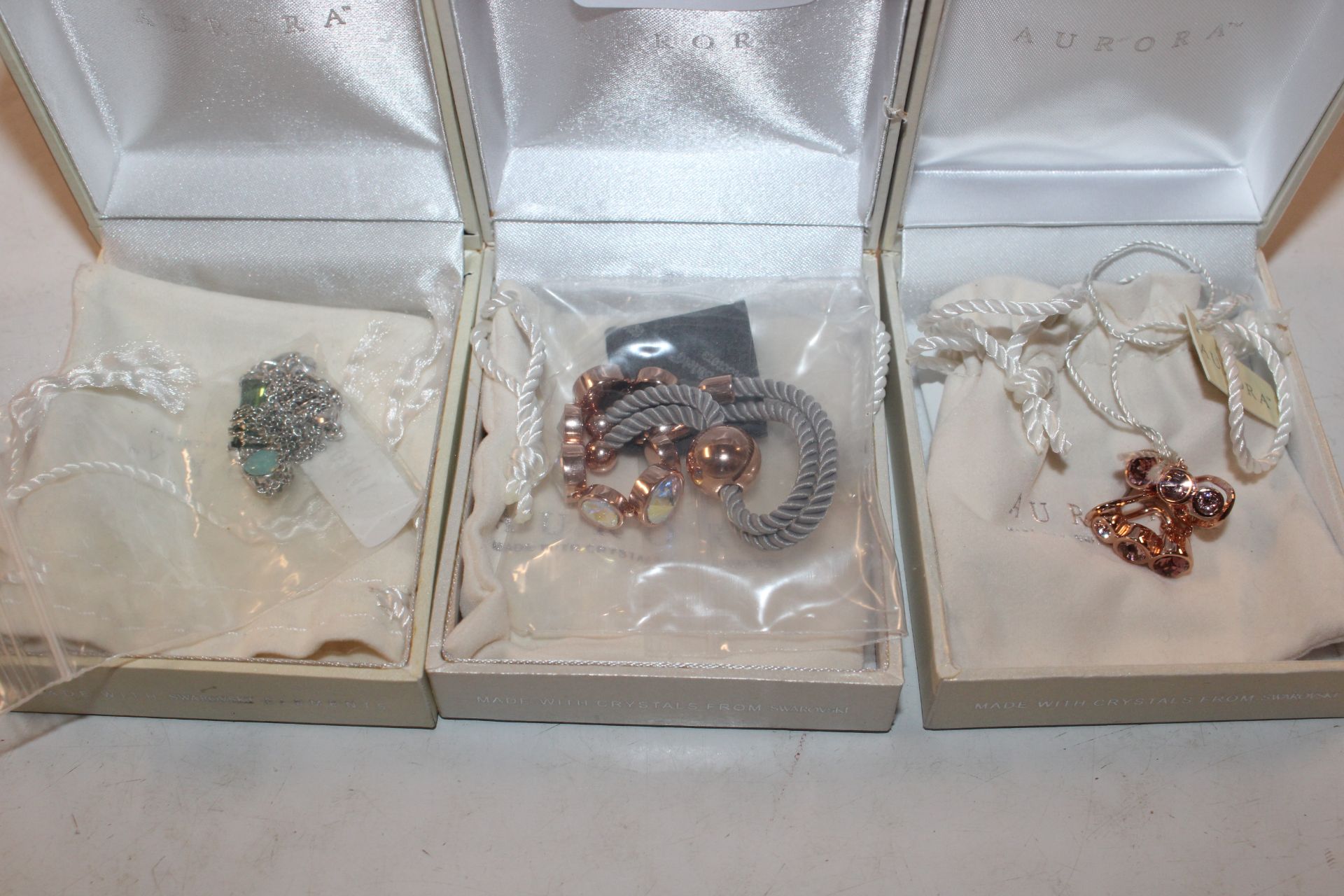 Three boxes containing Swarovski jewellery