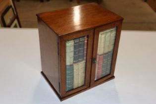 An oak cigar cabinet, the bevelled glass doors enc