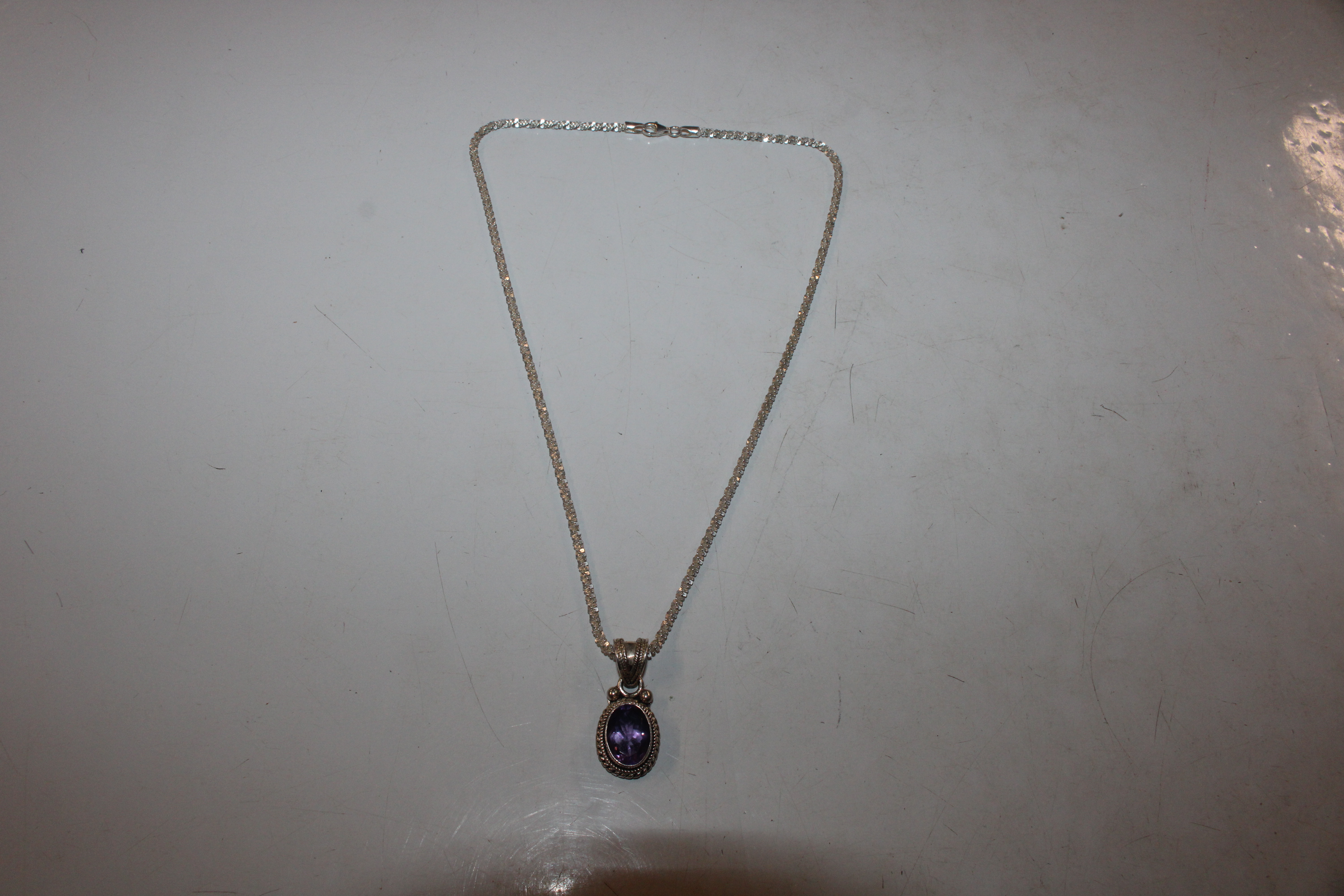 A Sterling silver and amethyst set pendant hung to - Image 2 of 6