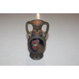 An Austrian pottery twin handled vase decorated wi
