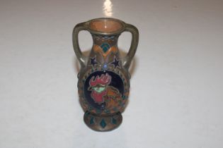 An Austrian pottery twin handled vase decorated wi