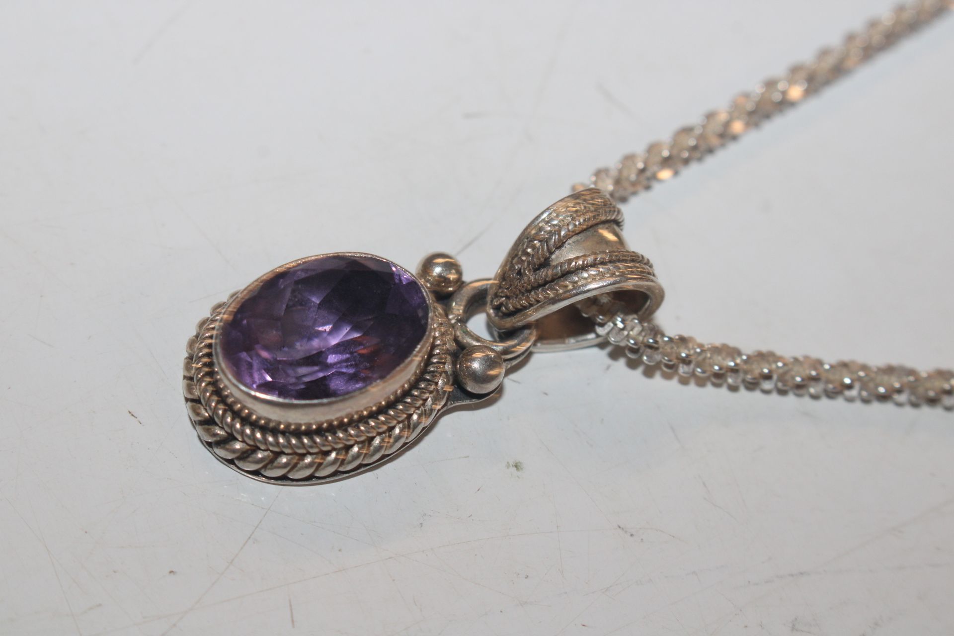 A Sterling silver and amethyst set pendant hung to - Image 3 of 6
