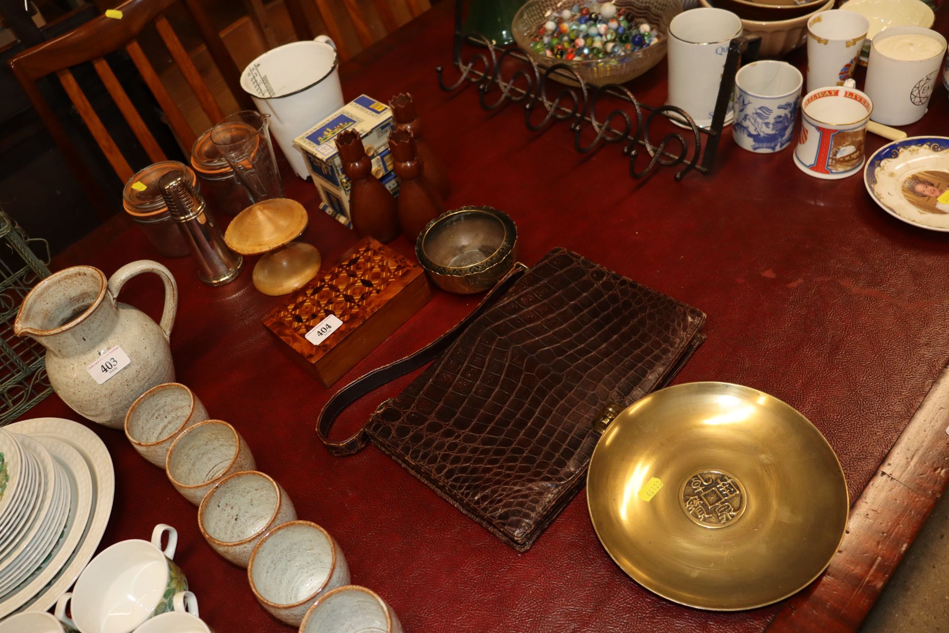 A vintage alligator skin handbag; an Oriental bras