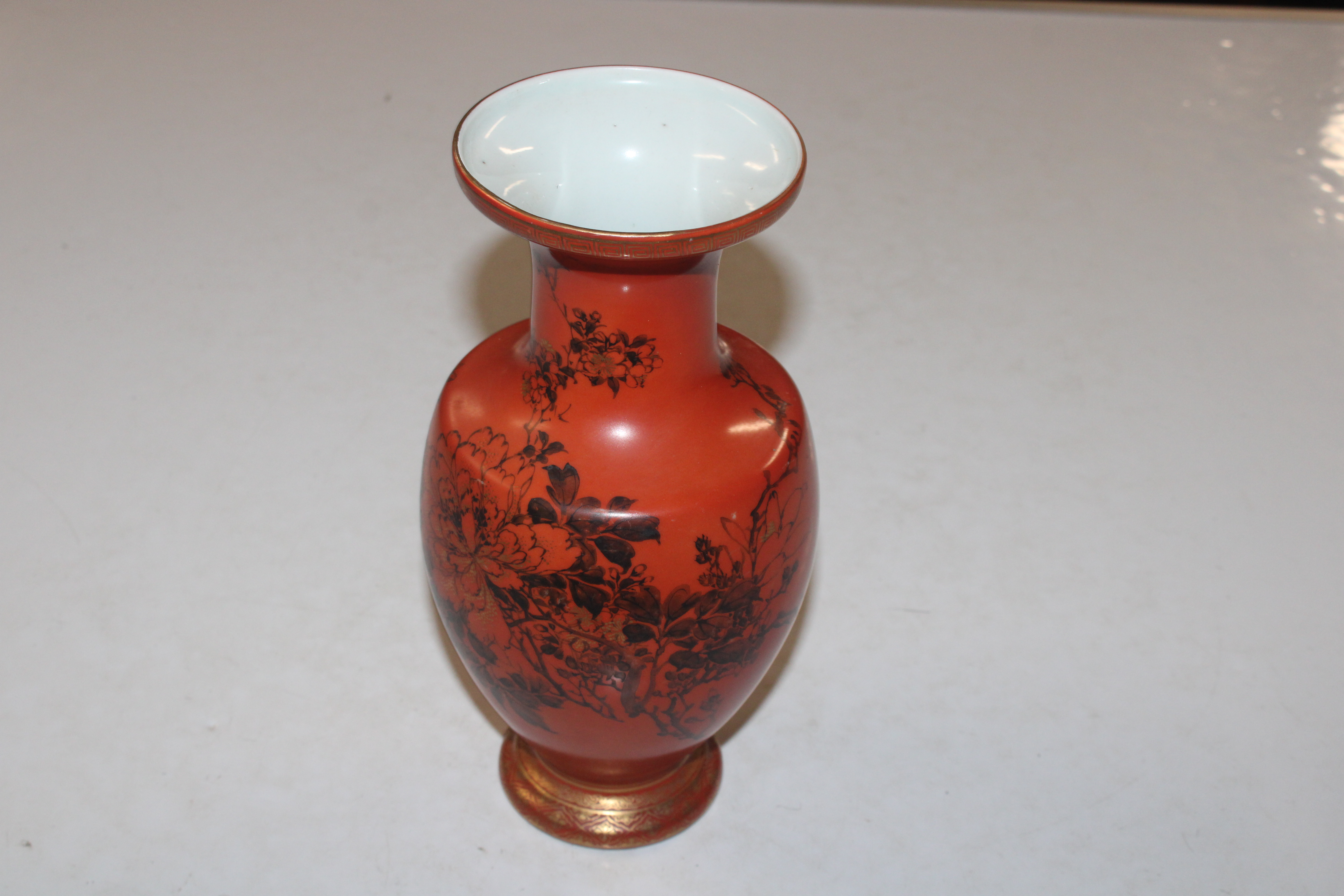 A Chinese vase having black and gilt decoration on