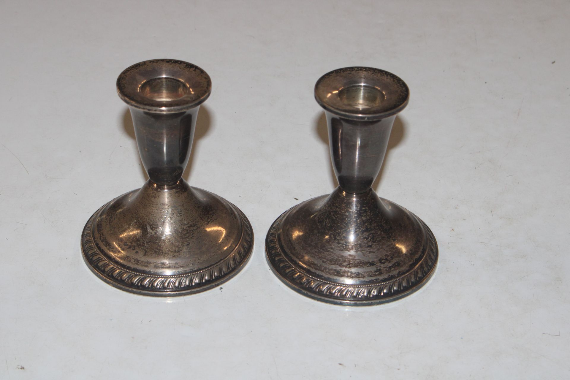 A pair of Sterling silver candlesticks with weight