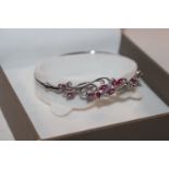 A Sterling silver diamond and tourmaline bangle