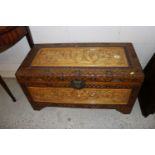 A Chinese carved camphor wood chest and contents o