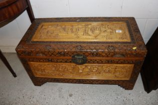 A Chinese carved camphor wood chest and contents o