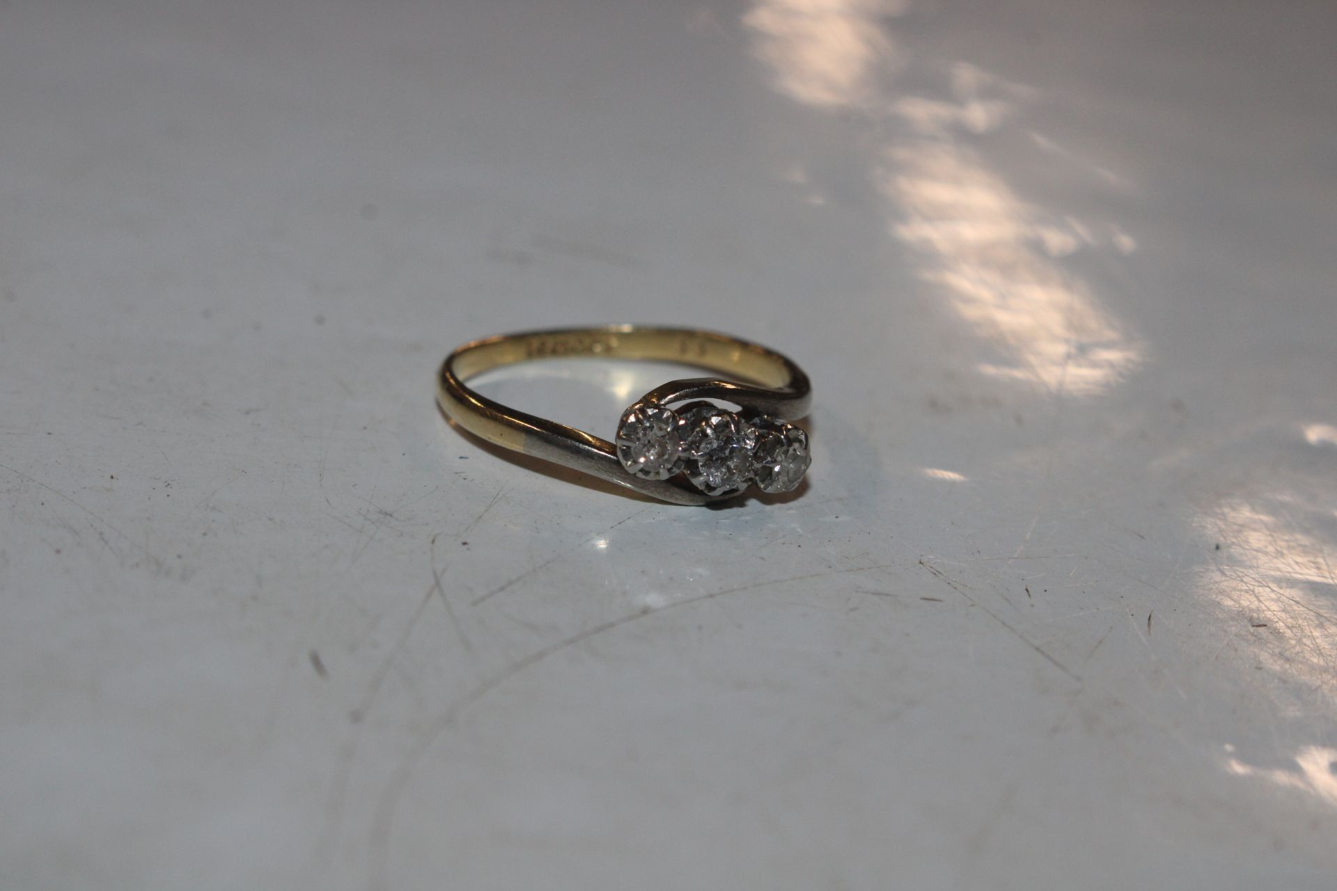 A 18ct gold and platinum diamond three stone ring,