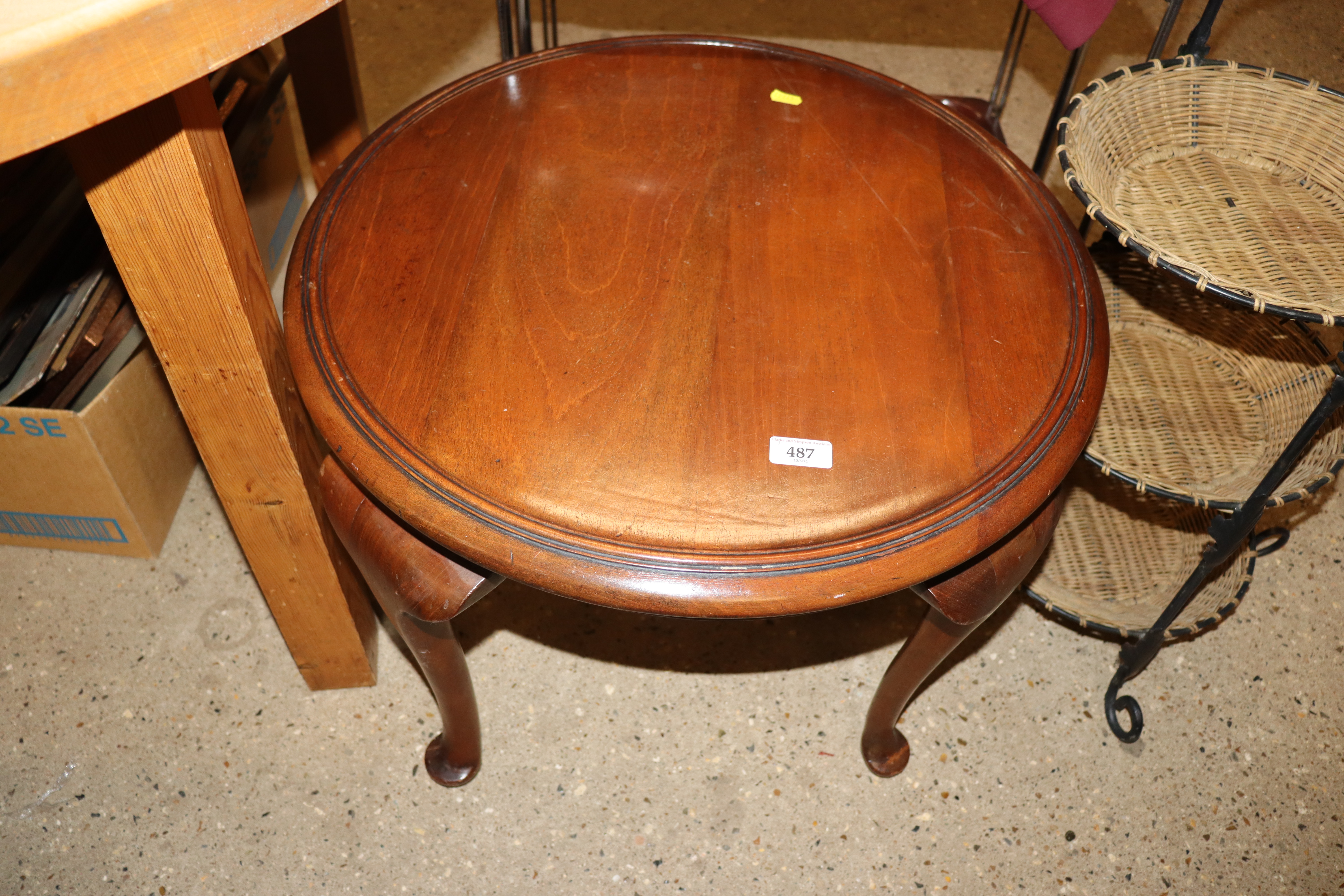 A mahogany circular topped table, raised on cabrio