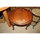 A mahogany circular topped table, raised on cabrio