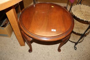 A mahogany circular topped table, raised on cabrio