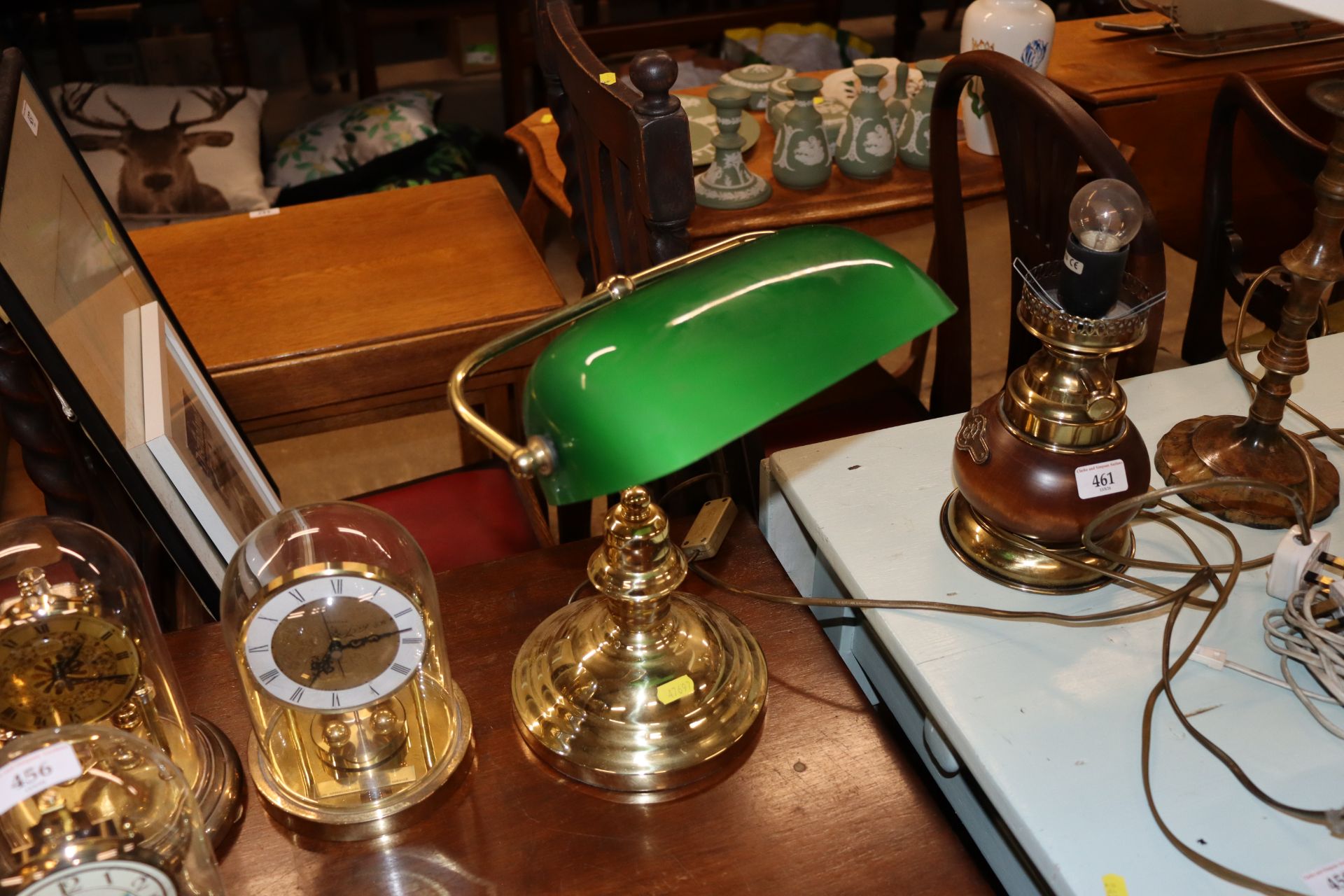 A brass desk lamp with green glass shade