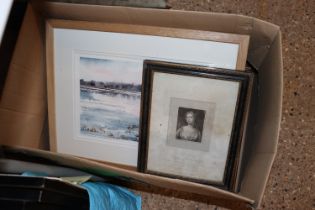 A box of various pictures and prints