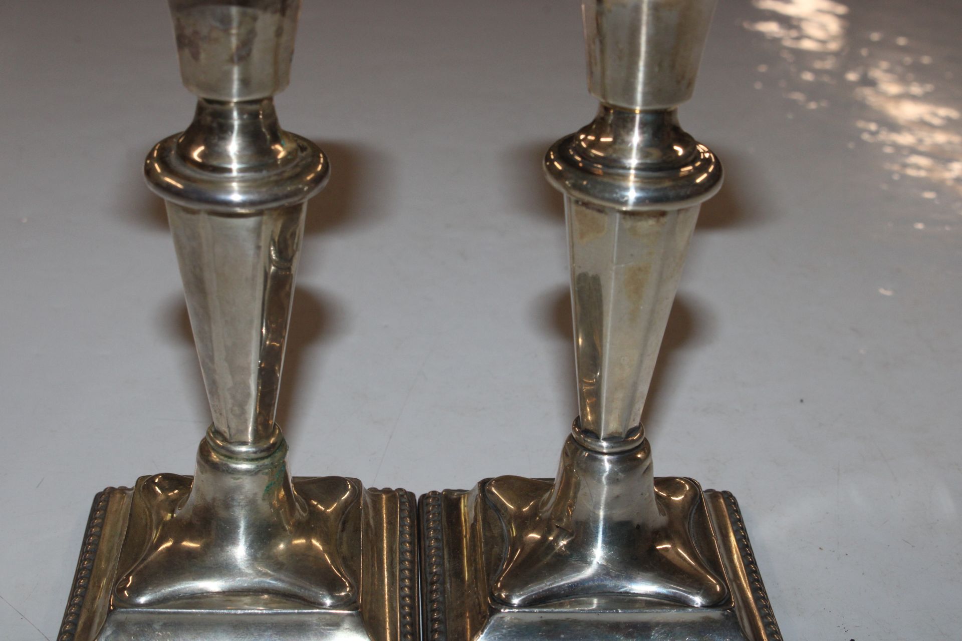 A pair of silver candlesticks with weighted bases - Image 3 of 7