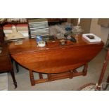 A cherrywood drop leaf dining table