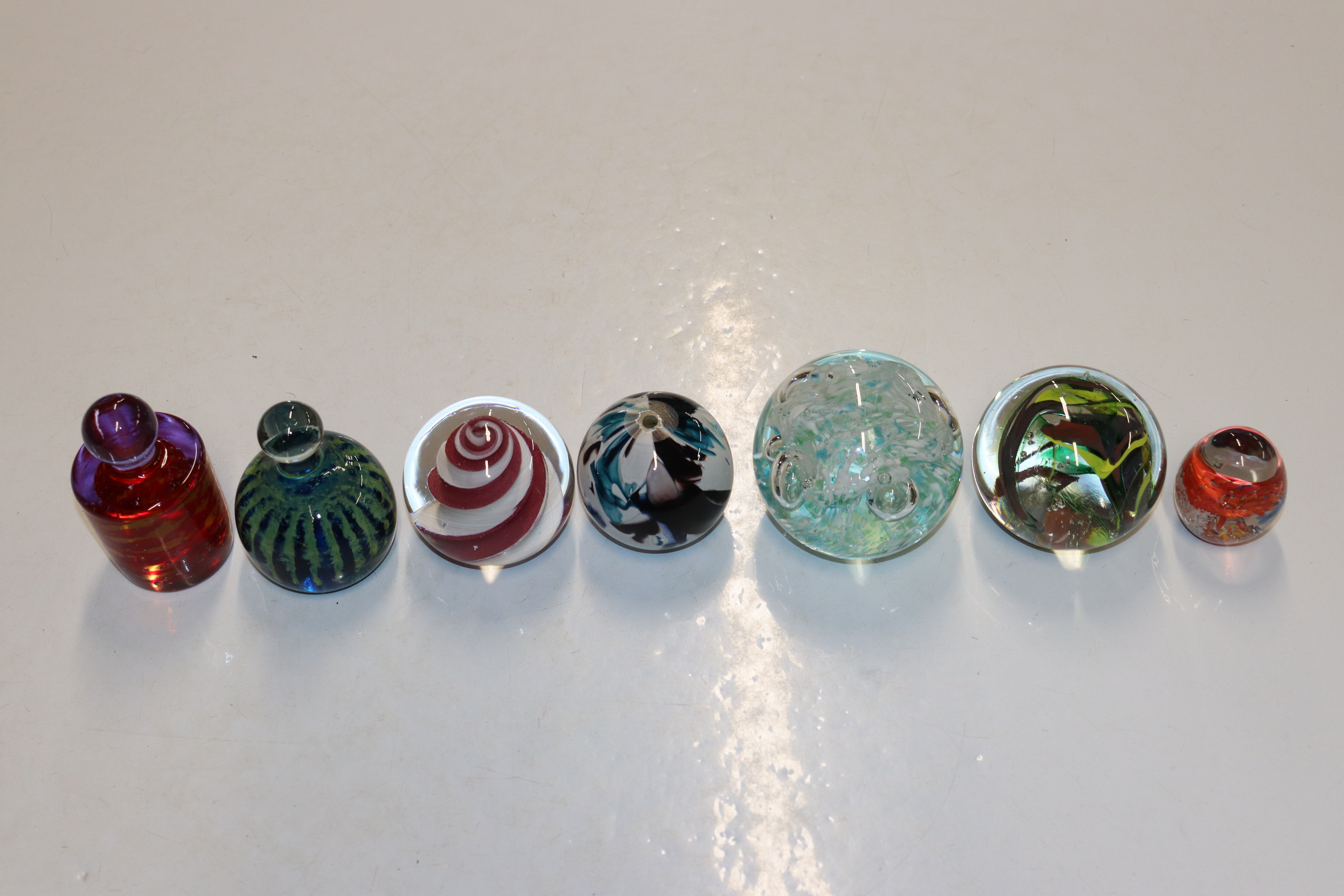 Seven various glass paperweights