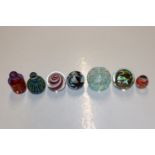 Seven various glass paperweights