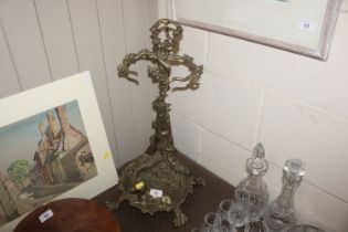 A cast brass stick stand with decoration of gun do