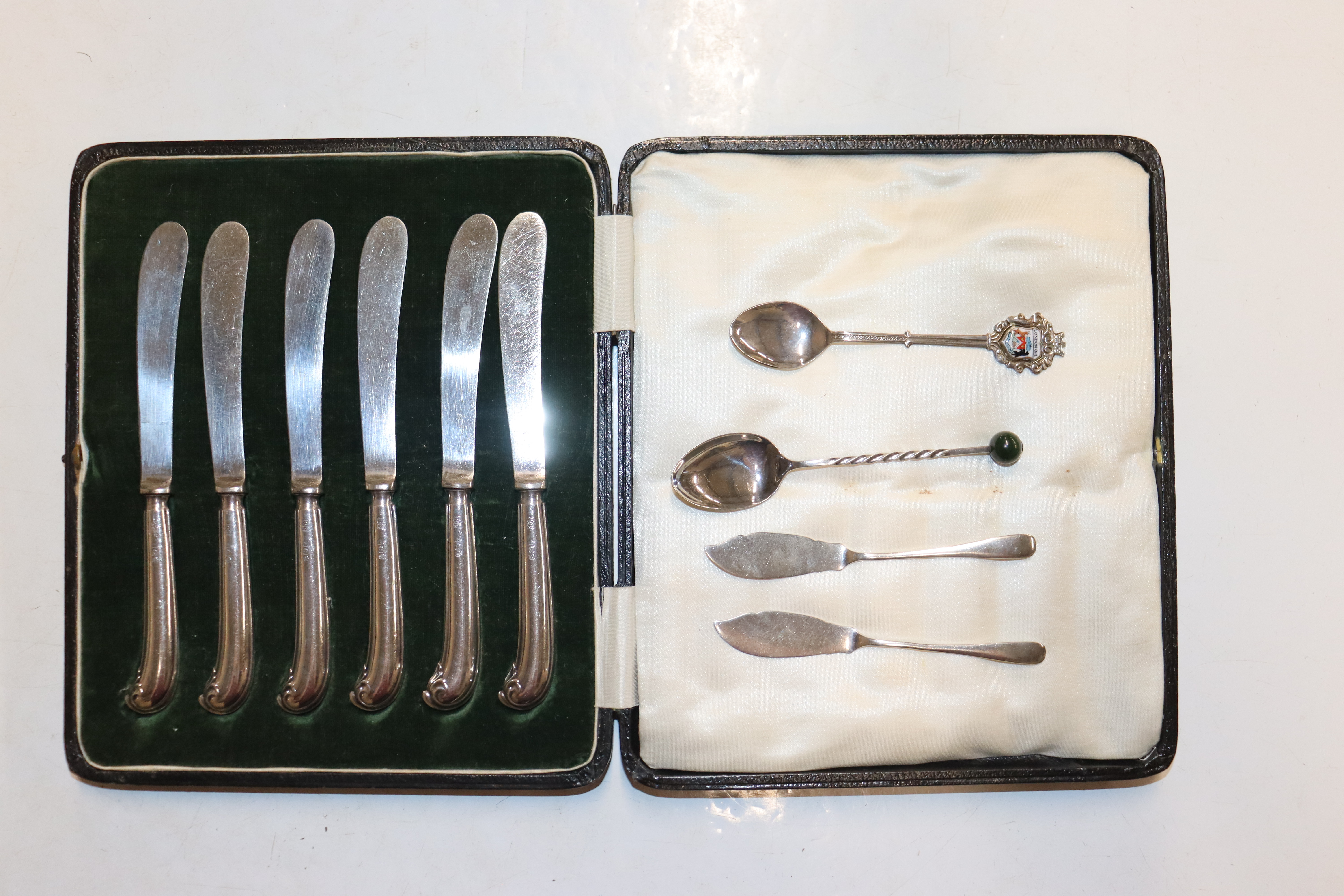 A cased set of six silver handled butter knives; t